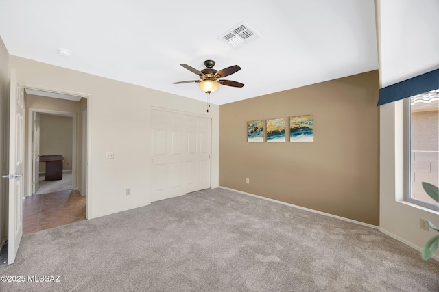 37358 S Ridgeview Blvd, Saddlebrooke, AZ 85739 - unfurnished bedroom featuring carpet flooring, a closet, baseboards, and a ceiling fan