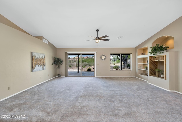 37358 S Ridgeview Blvd, Saddlebrooke, AZ 85739 - unfurnished living room with lofted ceiling, baseboards, ceiling fan, carpet, and built in shelves