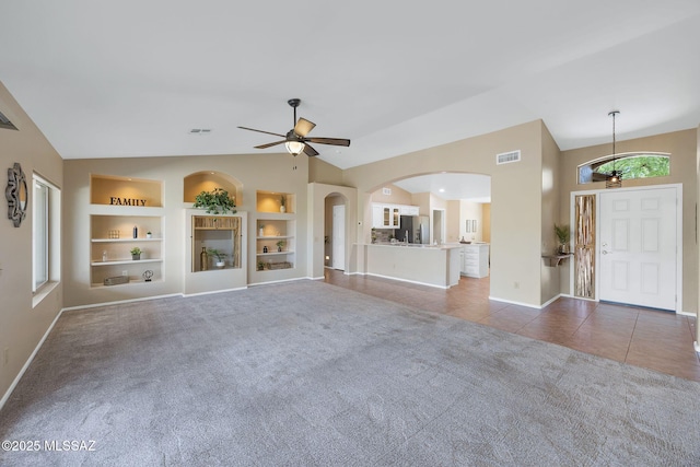 37358 S Ridgeview Blvd, Saddlebrooke, AZ 85739 - unfurnished living room with lofted ceiling, built in shelves, ceiling fan, and carpet