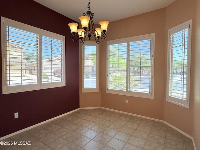 1320 W Bloomington Pl, Tucson, AZ 85755 - spare room with plenty of natural light, a chandelier, and baseboards