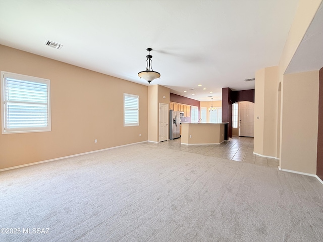 1320 W Bloomington Pl, Tucson, AZ 85755 - unfurnished living room featuring light colored carpet, baseboards, and recessed lighting