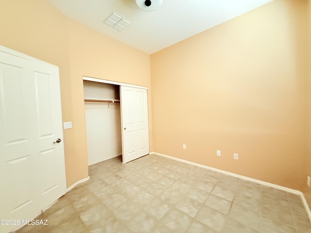 1320 W Bloomington Pl, Tucson, AZ 85755 - unfurnished bedroom with baseboards, light floors, and a closet