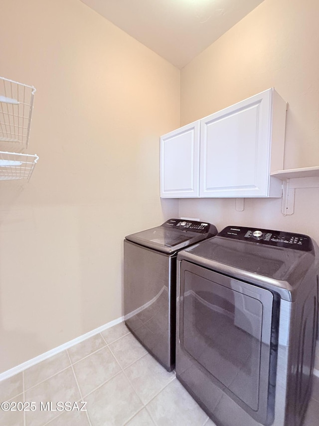 1320 W Bloomington Pl, Tucson, AZ 85755 - washroom featuring cabinet space, washing machine and clothes dryer, baseboards, and light tile patterned floors