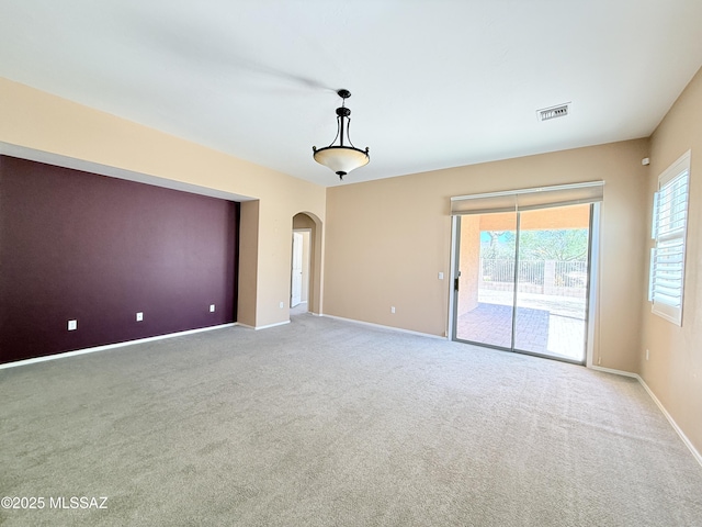 1320 W Bloomington Pl, Tucson, AZ 85755 - carpeted spare room featuring arched walkways and baseboards