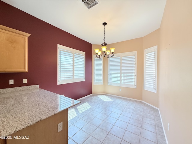 1320 W Bloomington Pl, Tucson, AZ 85755 - unfurnished dining area featuring a chandelier, plenty of natural light, light tile patterned floors, and baseboards