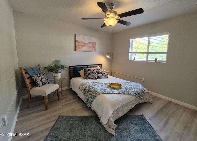 230 N Biddle Ave, Willcox, AZ 85643 - bedroom featuring light wood-style flooring, baseboards, and ceiling fan