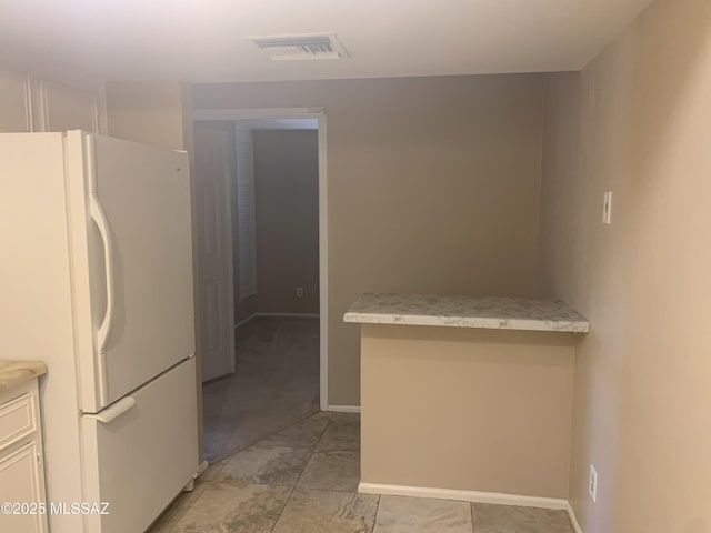 8271 N Oracle Rd Unit 146, Tucson, AZ 85704 - kitchen featuring freestanding refrigerator, light countertops, and white cabinetry