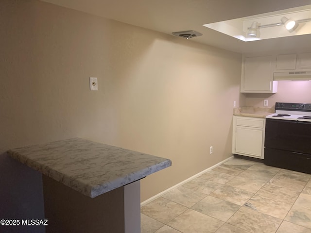 8271 N Oracle Rd Unit 146, Tucson, AZ 85704 - kitchen with electric range, under cabinet range hood, white cabinetry, a peninsula, and light countertops