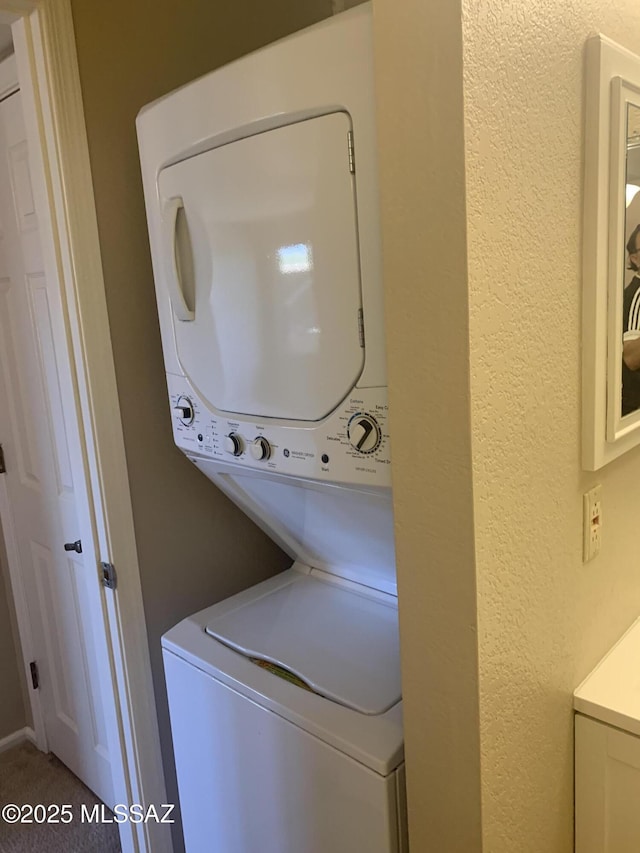 8271 N Oracle Rd Unit 146, Tucson, AZ 85704 - laundry room with estacked washer and dryer, a textured wall, and carpet floors