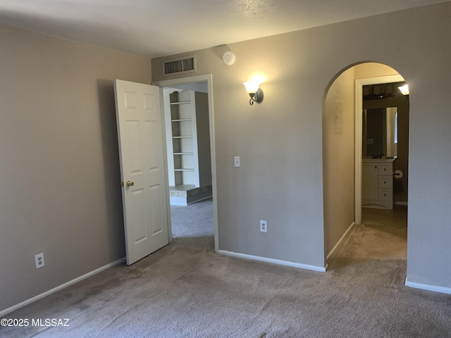 8271 N Oracle Rd Unit 146, Tucson, AZ 85704 - empty room featuring arched walkways, carpet floors, and a smoke detector