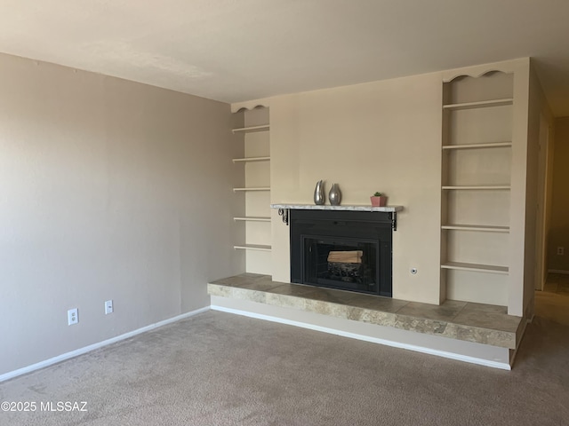8271 N Oracle Rd Unit 146, Tucson, AZ 85704 - unfurnished living room featuring a fireplace with raised hearth, carpet, and built in features