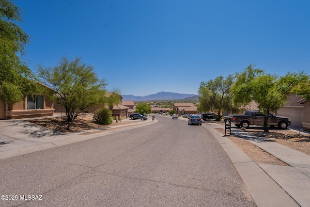 13218 E Mineta Ridge Dr, Vail, AZ 85641 - view of asphalt road featuring a mountain view, sidewalks, and curbs