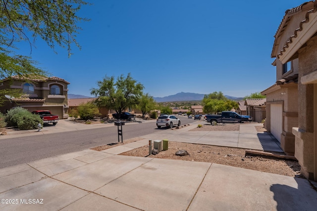 13218 E Mineta Ridge Dr, Vail, AZ 85641 - view of concrete road with a mountain view and sidewalks