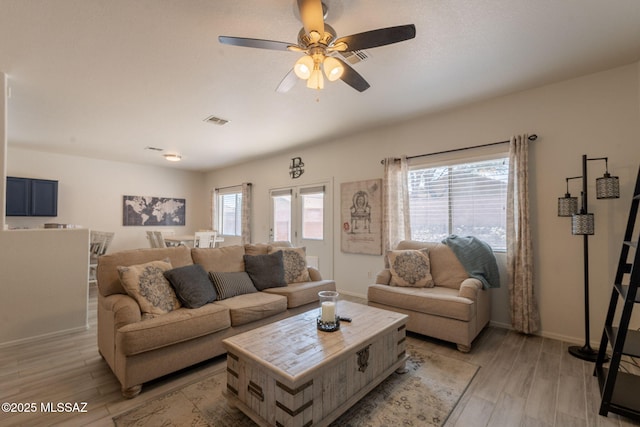 13218 E Mineta Ridge Dr, Vail, AZ 85641 - living area with plenty of natural light, light wood-style floors, and ceiling fan