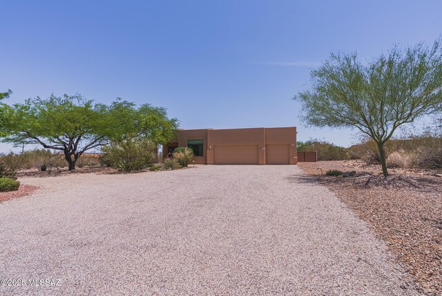 16567 S Saguaro View Ln, Vail, AZ 85641 - pueblo-style house with stucco siding, driveway, and a garage