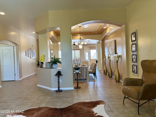 16567 S Saguaro View Ln, Vail, AZ 85641 - interior space with arched walkways, a chandelier, baseboards, light tile patterned flooring, and pendant lighting