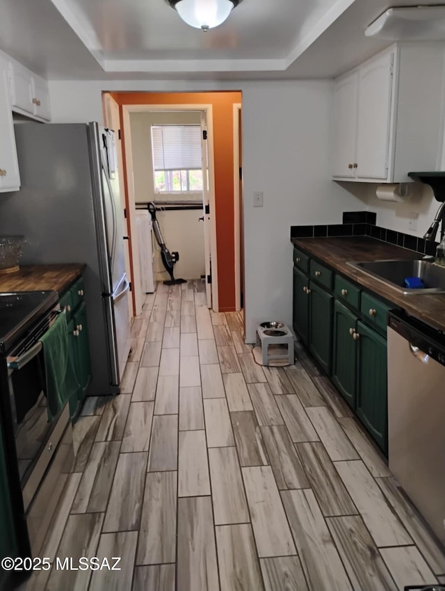242 N Sage St, Pearce, AZ 85625 - kitchen featuring appliances with stainless steel finishes, white cabinets, a raised ceiling, butcher block counters, and wood finish floors