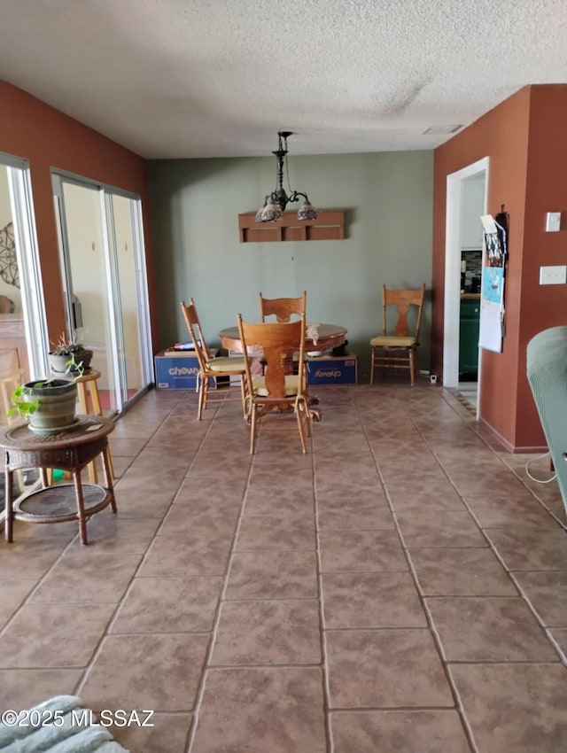 242 N Sage St, Pearce, AZ 85625 - tiled dining space featuring a textured ceiling