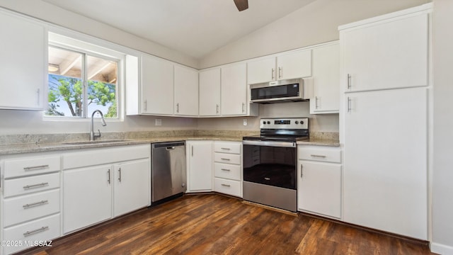 5701 E Waverly St, Tucson, AZ 85712 - kitchen with appliances with stainless steel finishes, a sink, vaulted ceiling, dark wood-type flooring, and white cabinetry