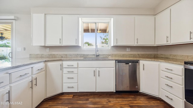 5701 E Waverly St, Tucson, AZ 85712 - kitchen featuring dishwasher, a sink, dark wood finished floors, white cabinets, and light stone counters