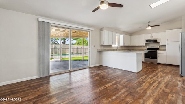 5701 E Waverly St, Tucson, AZ 85712 - kitchen featuring appliances with stainless steel finishes, a ceiling fan, a peninsula, lofted ceiling, and a sink