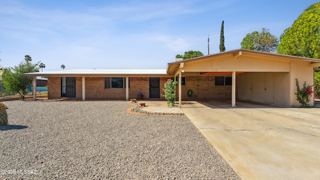 5701 E Waverly St, Tucson, AZ 85712 - ranch-style home featuring an attached carport, driveway, and brick siding