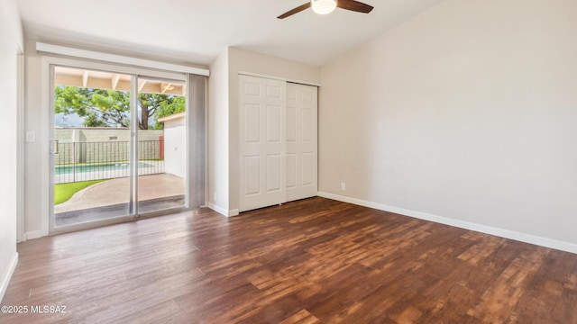 5701 E Waverly St, Tucson, AZ 85712 - unfurnished bedroom with access to outside, dark wood-style floors, baseboards, vaulted ceiling, and a closet