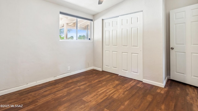 5701 E Waverly St, Tucson, AZ 85712 - unfurnished bedroom featuring dark wood-style flooring, baseboards, a closet, a ceiling fan, and vaulted ceiling
