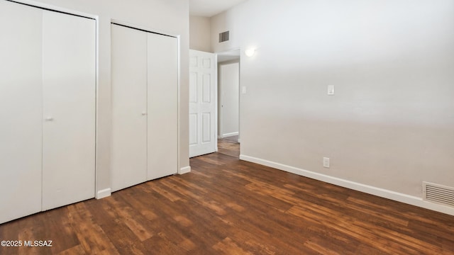 5701 E Waverly St, Tucson, AZ 85712 - unfurnished bedroom with two closets, wood finished floors, and baseboards