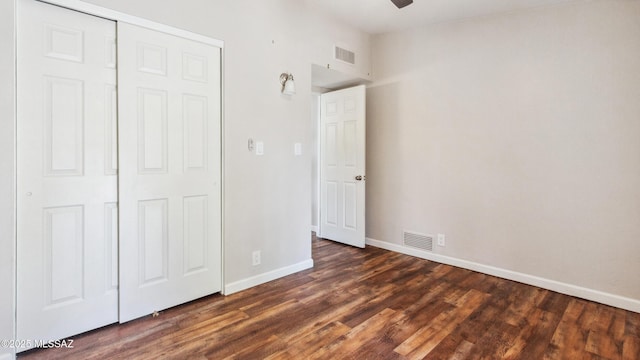 5701 E Waverly St, Tucson, AZ 85712 - unfurnished bedroom featuring baseboards, dark wood-style floors, and a closet