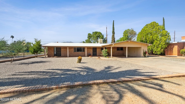 5701 E Waverly St, Tucson, AZ 85712 - single story home with concrete driveway, an attached carport, and brick siding