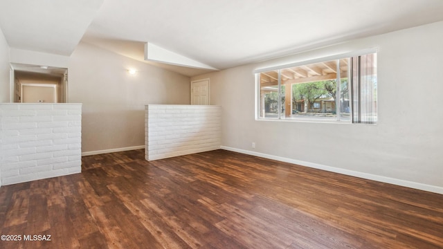 5701 E Waverly St, Tucson, AZ 85712 - empty room with wood finished floors, baseboards, and lofted ceiling