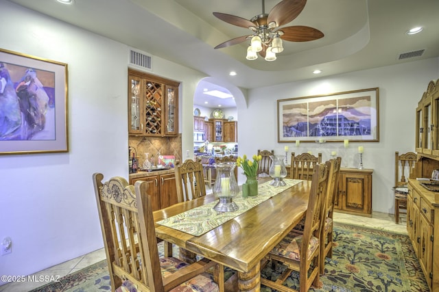 2460 N Cavalry Trl, Tucson, AZ 85749 - dining space with arched walkways, ceiling fan, recessed lighting, and light tile patterned floors