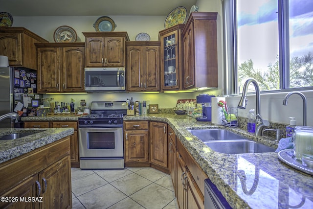 2460 N Cavalry Trl, Tucson, AZ 85749 - kitchen featuring stainless steel appliances, a sink, light tile patterned floors, and light stone counters