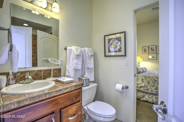 2460 N Cavalry Trl, Tucson, AZ 85749 - bathroom featuring vanity, ensuite bath, and toilet