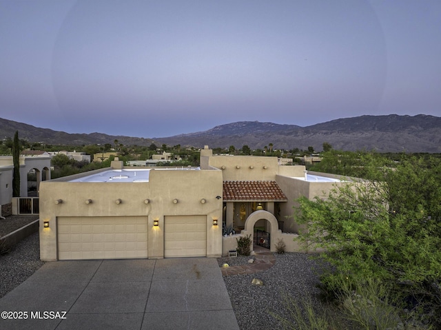 2460 N Cavalry Trl, Tucson, AZ 85749 - view of front of property featuring a chimney, stucco siding, a mountain view, and an attached garage