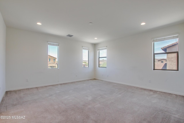 13391 N Flaxleaf Pl, Oro Valley, AZ 85755 - unfurnished room with healthy amount of natural light, light colored carpet, recessed lighting, and baseboards