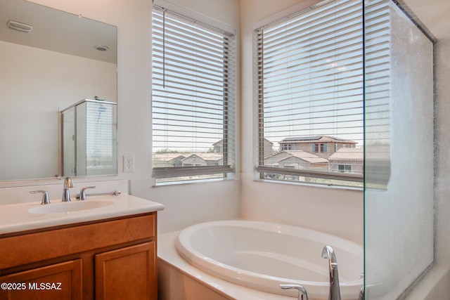 13391 N Flaxleaf Pl, Oro Valley, AZ 85755 - bathroom featuring plenty of natural light, a garden tub, vanity, and an enclosed shower