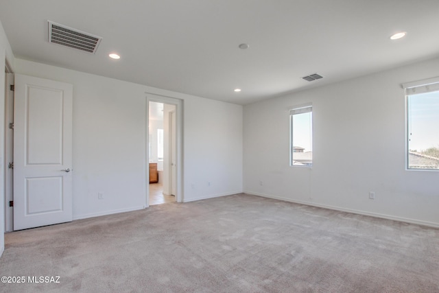 13391 N Flaxleaf Pl, Oro Valley, AZ 85755 - empty room featuring plenty of natural light, light carpet, recessed lighting, and baseboards