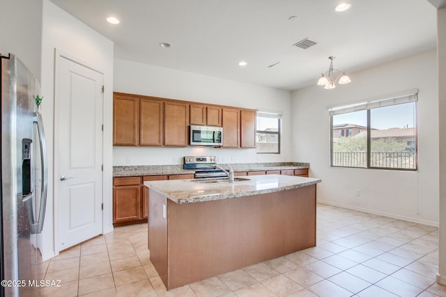 13391 N Flaxleaf Pl, Oro Valley, AZ 85755 - kitchen with appliances with stainless steel finishes, light tile patterned floors, brown cabinetry, and recessed lighting