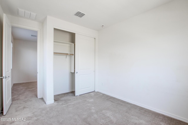 13391 N Flaxleaf Pl, Oro Valley, AZ 85755 - unfurnished bedroom with carpet flooring, a closet, and baseboards