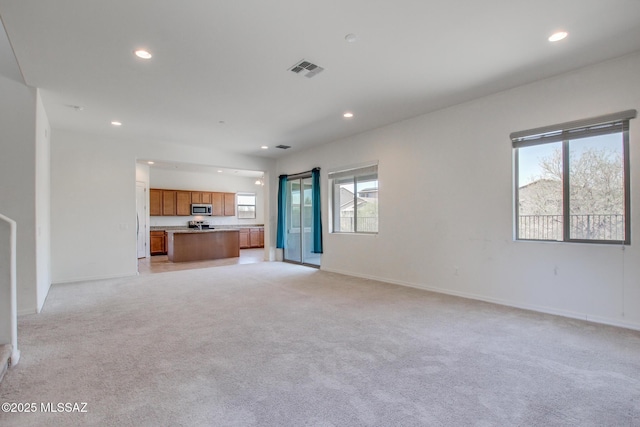 13391 N Flaxleaf Pl, Oro Valley, AZ 85755 - unfurnished living room featuring recessed lighting, light colored carpet, and baseboards