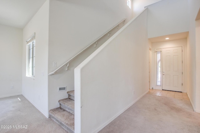 13391 N Flaxleaf Pl, Oro Valley, AZ 85755 - entryway with carpet floors, stairway, and baseboards