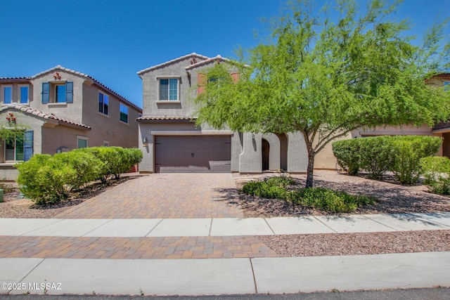 13391 N Flaxleaf Pl, Oro Valley, AZ 85755 - view of front facade featuring an attached garage, stucco siding, decorative driveway, and a tiled roof