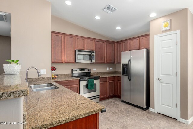 4112 E Shadow Branch Dr, Tucson, AZ 85756 - kitchen with appliances with stainless steel finishes, a sink, vaulted ceiling, light tile patterned flooring, and recessed lighting
