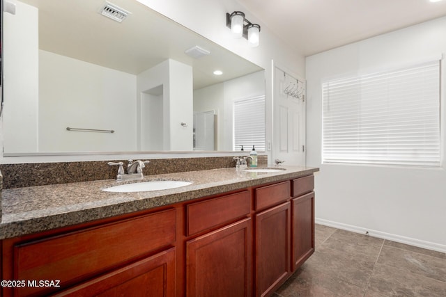 4112 E Shadow Branch Dr, Tucson, AZ 85756 - bathroom featuring double vanity, baseboards, and tile patterned flooring