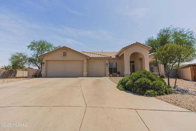 6805 W Tombstone Way, Tucson, AZ 85743 - view of front facade with stucco siding, concrete driveway, a garage, and a tile roof