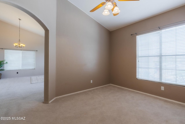 6805 W Tombstone Way, Tucson, AZ 85743 - unfurnished room featuring lofted ceiling, light colored carpet, a ceiling fan, a chandelier, and arched walkways