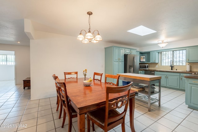 2501 W Calle Paraiso, Tucson, AZ 85745 - dining area featuring light tile patterned floors, healthy amount of natural light, and a skylight