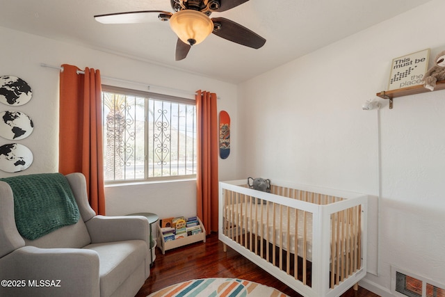 2501 W Calle Paraiso, Tucson, AZ 85745 - bedroom featuring wood finished floors, ceiling fan, and a crib